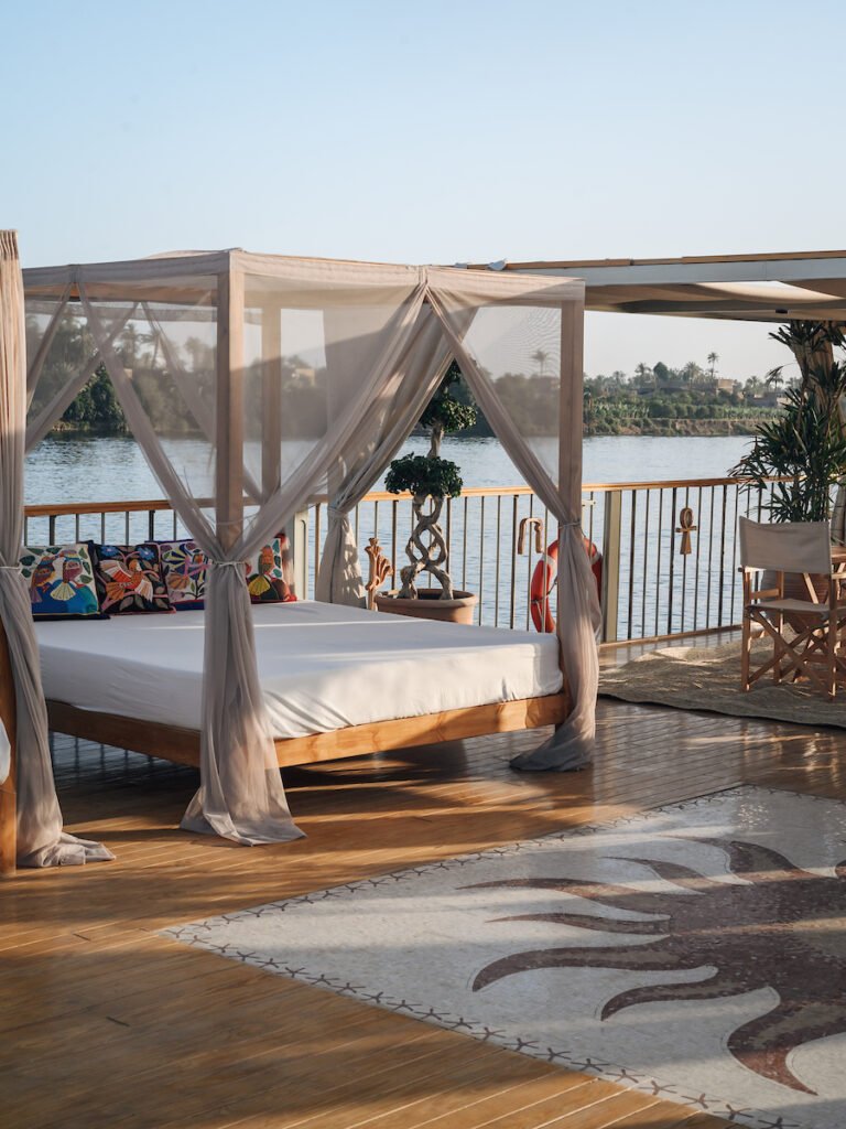 Royal bed under a canopy on the Nile Divine upper deck