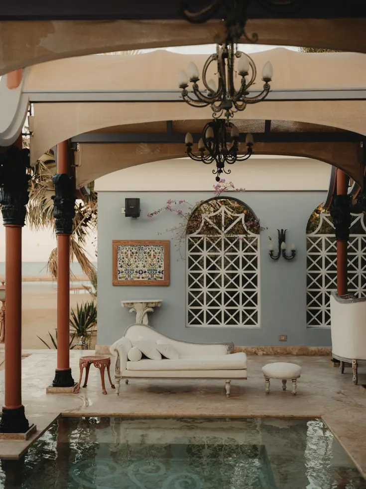 Pool with sofas and daybeds at La Maison Bleue
