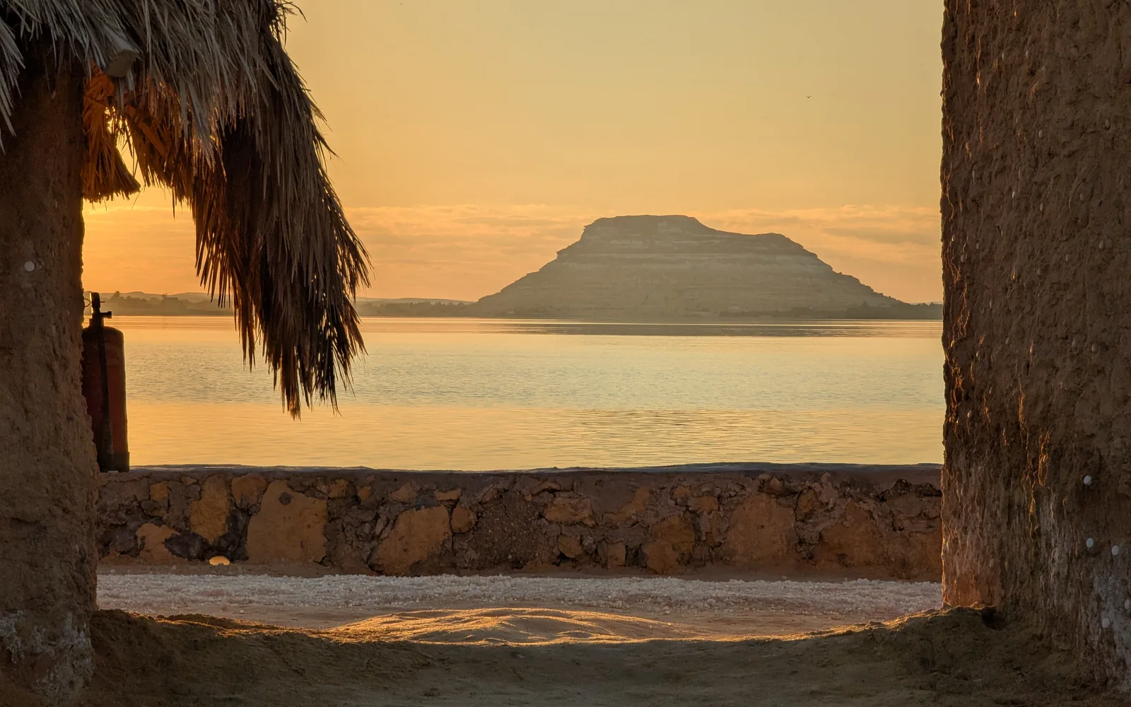 Shaded lakeside shelter looking over a salt lake at Siwa, Egypt